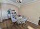 Modern dining area with round glass top table and four light grey chairs at 12021 Villanova Dr # 111, Orlando, FL 32837