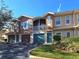 Two-story condo building with attached garages and balconies at 12021 Villanova Dr # 111, Orlando, FL 32837