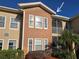 Condo building showcasing a tan facade and balconies at 12021 Villanova Dr # 111, Orlando, FL 32837
