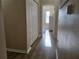 Bright hallway with wood-look flooring and access to bedrooms at 12021 Villanova Dr # 111, Orlando, FL 32837