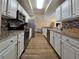 Modern kitchen with white cabinets, stainless steel appliances and granite countertops at 12021 Villanova Dr # 111, Orlando, FL 32837