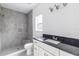 Modern bathroom with gray tile shower and granite vanity at 1334 Dean Ave, Eustis, FL 32726