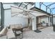 Spacious backyard patio with covered seating area, fire pit, and large umbrella at 13384 Leggett Aly, Orlando, FL 32827