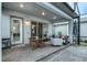 Covered patio features a table and chairs, comfortable seating, and a view of the yard at 13384 Leggett Aly, Orlando, FL 32827