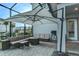 Relaxing backyard patio with fire pit, seating area, and large umbrella for shade at 13384 Leggett Aly, Orlando, FL 32827