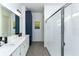 Modern bathroom with double vanity, navy blue cabinets, and a glass shower at 13384 Leggett Aly, Orlando, FL 32827