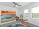 Bright bedroom with bunk beds, built-in shelving, and playful rug at 13384 Leggett Aly, Orlando, FL 32827