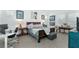 Bright bedroom with a wooden bed frame, desk, and tile floors at 13384 Leggett Aly, Orlando, FL 32827