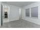 Well-lit bedroom with carpet flooring and access to laundry and another bedroom at 13384 Leggett Aly, Orlando, FL 32827
