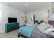 Bedroom with teal bedding, built-in shelving, and a view into the bathroom at 13384 Leggett Aly, Orlando, FL 32827