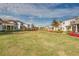 Green lawn, homes with landscaping, red chairs at 13384 Leggett Aly, Orlando, FL 32827