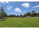 Expansive green lawn with parking and community buildings in the background at 13384 Leggett Aly, Orlando, FL 32827