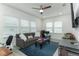 Bright Gathering room features a comfy sofa, large TV, and ample natural light at 13384 Leggett Aly, Orlando, FL 32827