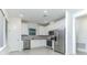 Modern kitchen boasts stainless steel appliances and sleek white cabinetry at 13384 Leggett Aly, Orlando, FL 32827