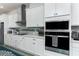 White kitchen cabinets, stainless steel appliances, quartz counters at 13384 Leggett Aly, Orlando, FL 32827