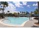 Resort-style pool with palm trees and lounge chairs at 13384 Leggett Aly, Orlando, FL 32827