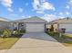 Curb appeal abounds in this charming one-story home featuring a two-car garage and well-manicured landscaping at 1807 Brisbane Pl, Davenport, FL 33837