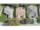 Three homes with different roof styles and landscaping, viewed from above at 2039 Palo Alto Ave, Lady Lake, FL 32159