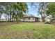 Spacious backyard with large trees and a picnic table at 2404 Chase Ave, Sanford, FL 32771