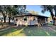 Tan house with multiple windows, wooden steps, and a grassy yard at 2404 Chase Ave, Sanford, FL 32771