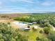 Aerial view of waterfront property with a home, pond, and outbuildings at 2570 Canvasback Trl, Geneva, FL 32732
