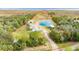 Aerial view shows home, pond, and waterfront property at 2570 Canvasback Trl, Geneva, FL 32732