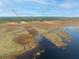 Aerial view of property and surrounding marshland at 2570 Canvasback Trl, Geneva, FL 32732