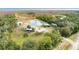 Aerial view of a home on a large lot with a pond, multiple buildings and waterfront access at 2570 Canvasback Trl, Geneva, FL 32732