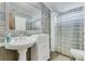 Clean bathroom with pedestal sink, shower, and wood-look floors at 2570 Canvasback Trl, Geneva, FL 32732