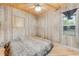 Cozy bedroom with wood-paneled walls and a king-size bed at 2570 Canvasback Trl, Geneva, FL 32732