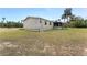 Tan mobile home with covered patio, screened porch, and large yard at 2570 Canvasback Trl, Geneva, FL 32732