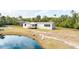Single-story home exterior with a porch and pond view at 2570 Canvasback Trl, Geneva, FL 32732