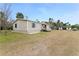 Tan mobile home with large yard and detached workshop at 2570 Canvasback Trl, Geneva, FL 32732