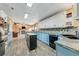 Open kitchen with light blue cabinets, a large island, and stone backsplash at 2570 Canvasback Trl, Geneva, FL 32732