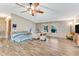 Living room with hardwood floors, stone accent wall and a ceiling fan at 2570 Canvasback Trl, Geneva, FL 32732