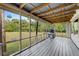 Relaxing screened porch with wood flooring, overlooking a large backyard at 2570 Canvasback Trl, Geneva, FL 32732