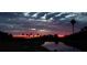 Stunning sunset view over a tranquil pond and palm trees at 2570 Canvasback Trl, Geneva, FL 32732