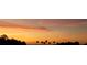 Orange and yellow sunset over calm water and palm trees at 2570 Canvasback Trl, Geneva, FL 32732
