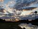 Scenic sunset view over calm waters with palm trees at 2570 Canvasback Trl, Geneva, FL 32732