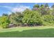 Landscaped backyard with various trees and lush greenery at 2647 Zuni Rd, St Cloud, FL 34771