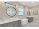 Spa-like bathroom with double vanity, soaking tub and round mirrors at 2647 Zuni Rd, St Cloud, FL 34771
