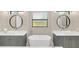 Elegant bathroom with double vanities, a large soaking tub, and modern fixtures at 2647 Zuni Rd, St Cloud, FL 34771