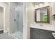 Modern bathroom with a gray vanity and a herringbone-tiled shower at 2647 Zuni Rd, St Cloud, FL 34771