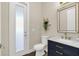 Stylish powder room with navy vanity and gold accents at 2647 Zuni Rd, Saint Cloud, FL 34771