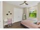 Bright bedroom with a queen-size bed and built-in window seat at 2647 Zuni Rd, St Cloud, FL 34771