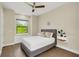 Cozy bedroom with a gray upholstered bed and built-in window seat at 2647 Zuni Rd, St Cloud, FL 34771