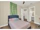 Charming bedroom with a comfortable bed and an accent wall at 2647 Zuni Rd, St Cloud, FL 34771