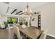 Elegant dining room with chandelier and view to kitchen at 2647 Zuni Rd, St Cloud, FL 34771