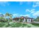 Home showcasing a three-car garage and manicured landscaping at 2647 Zuni Rd, Saint Cloud, FL 34771