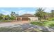 House exterior with a three-car garage and a large yard at 2647 Zuni Rd, St Cloud, FL 34771